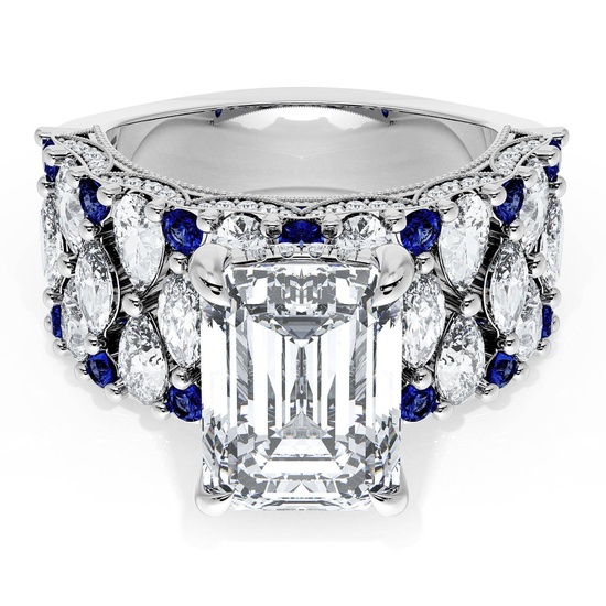 An elegant white gold ring with a large emerald cut center diamond surrounded by marquise diamonds and round blue sapphires.