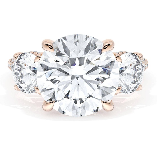 A luxurious three-stone diamond ring from TACORI, featuring a large round center diamond flanked by two smaller diamonds set in a rose gold band.
