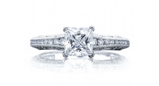 a white gold engagement ring with a princess cut center stone and milgrain detailing
