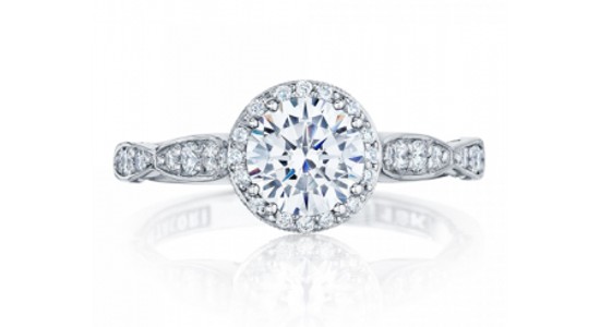 a white gold engagement ring with a round cut, halo set center stone