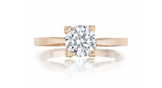 a rose gold engagement ring featuring a round cut diamond four prongs
