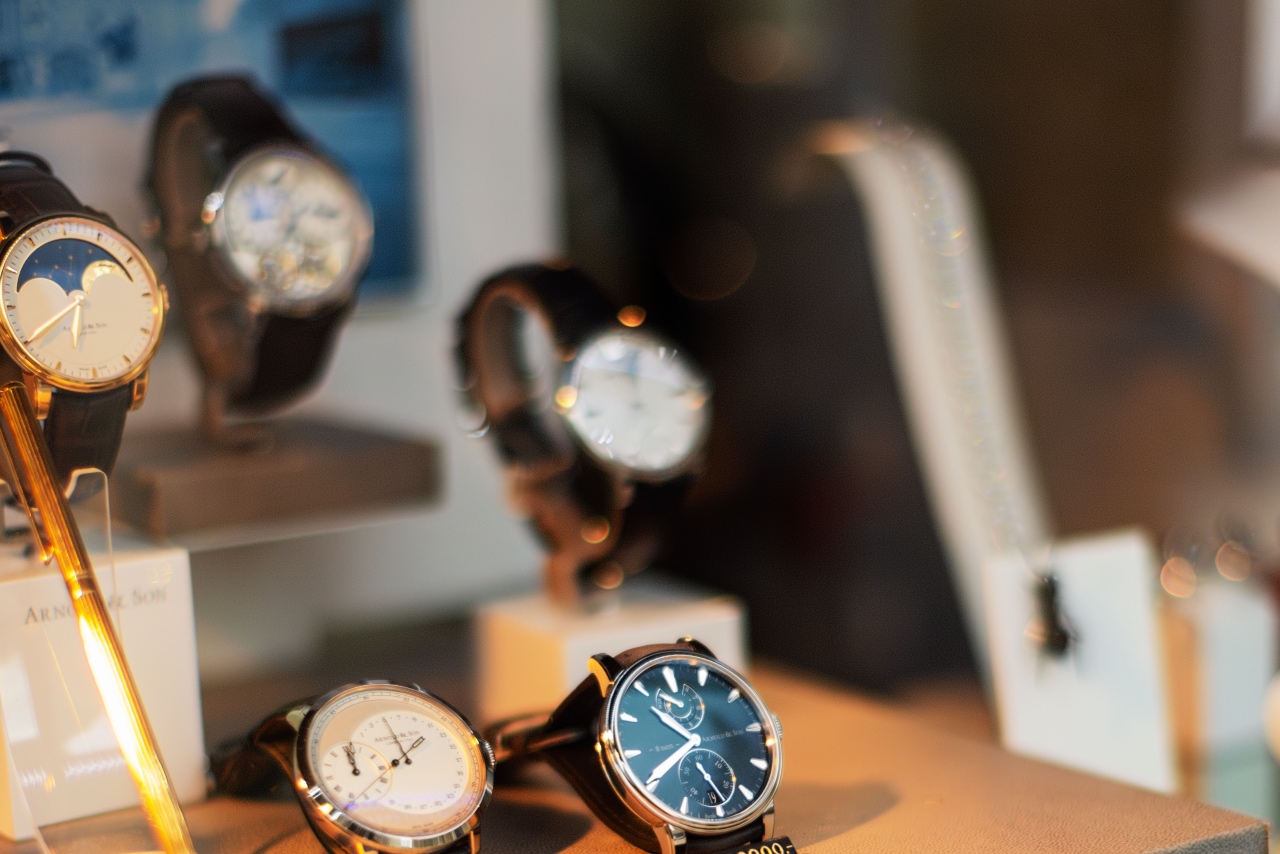 A luxury display window featuring several high-end watches on stands.