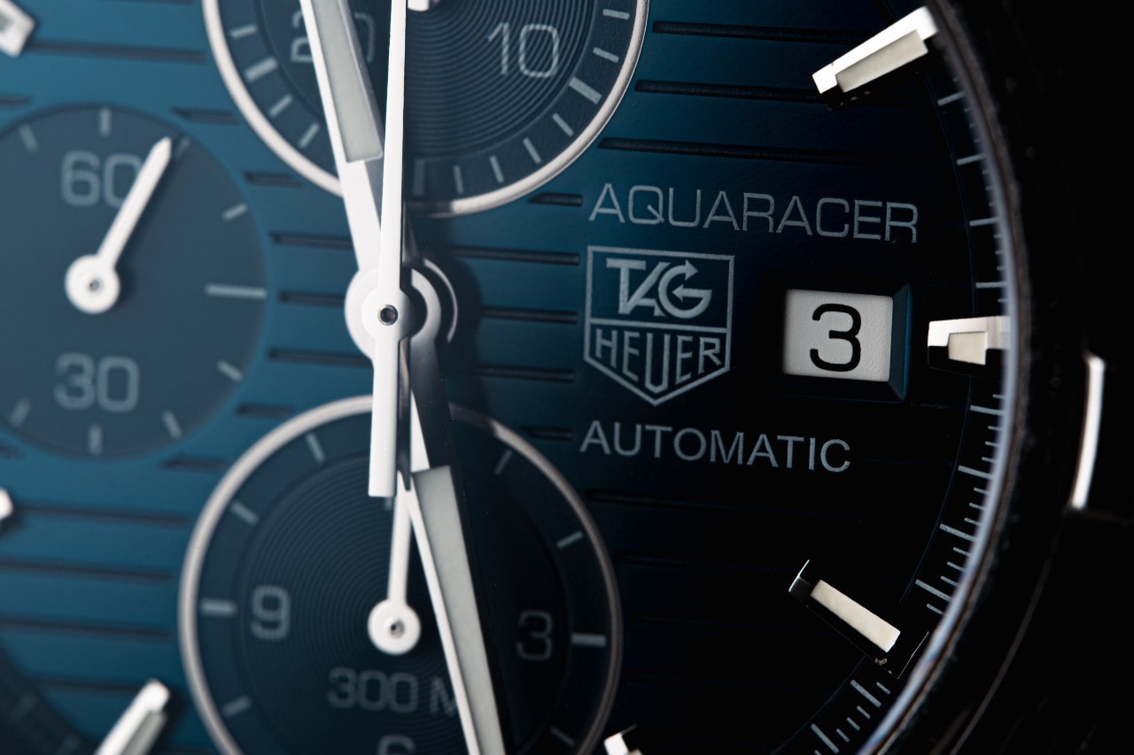 A close-up of a blue dial TAG Heuer Aquaracer Automatic chronograph watch face.