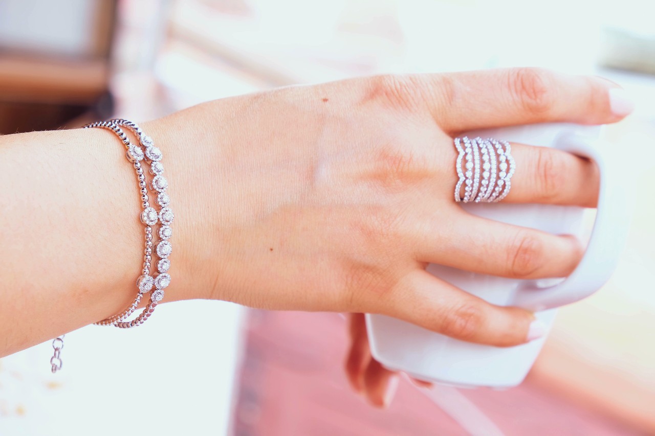 woman hands wearing diamond rings and diamond bracelet