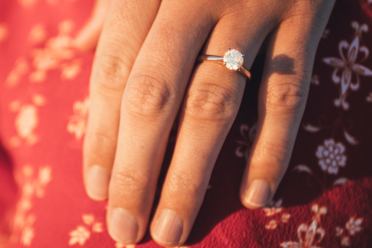 A radiant stone in a solitaire setting shining in the sunset